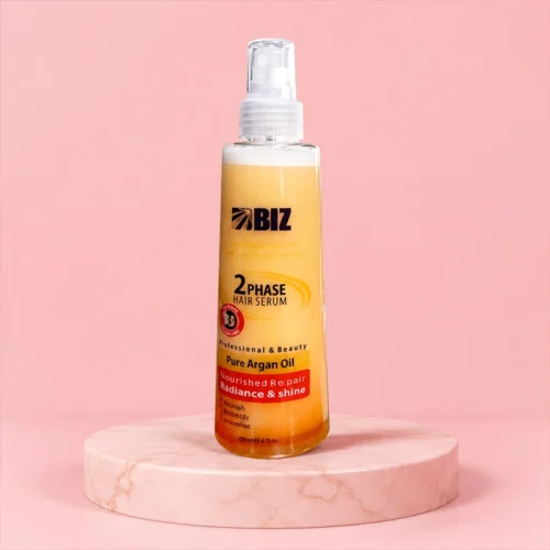 BIZ 2Phase Hair Serum Bottle Positioned on Reflective Orange Surface